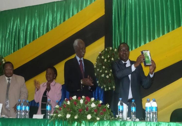  Prof. Gerald C. Monela showing off a token awarded to him during his farewell party. Looking on from right to left is The Chancellor of Sokoine University of Agriculture Hon. Judge (retired) Joseph Sinde Warioba, Deputy Chairperson of SUA Council Prof. Ester Mwaikambo and SUA’s Deputy Vice Chancellor – Administration and Finance Prof. Yonika Ngaga. 