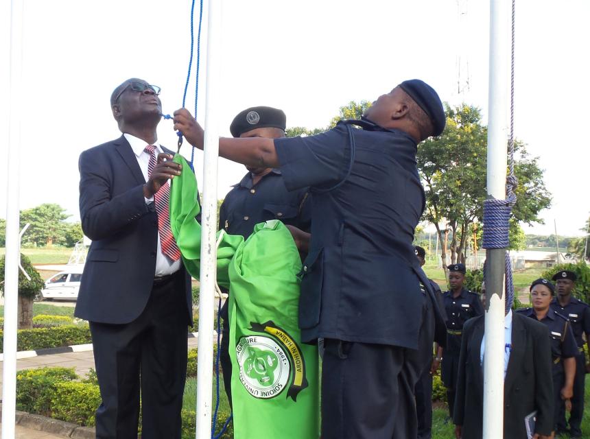 Makamu wa Mkuu wa Chuo Kikuu cha Sokoine cha Kilimo Prof Raphael Chibunda akisaidiana na Mkuu wa Usalama wa SUA Afande Mtunguja kupandisha bendera ya SUA hii ikiwa ni mara ya kwanza tangu kupatikana kwa bendera hiyo ya Chuo