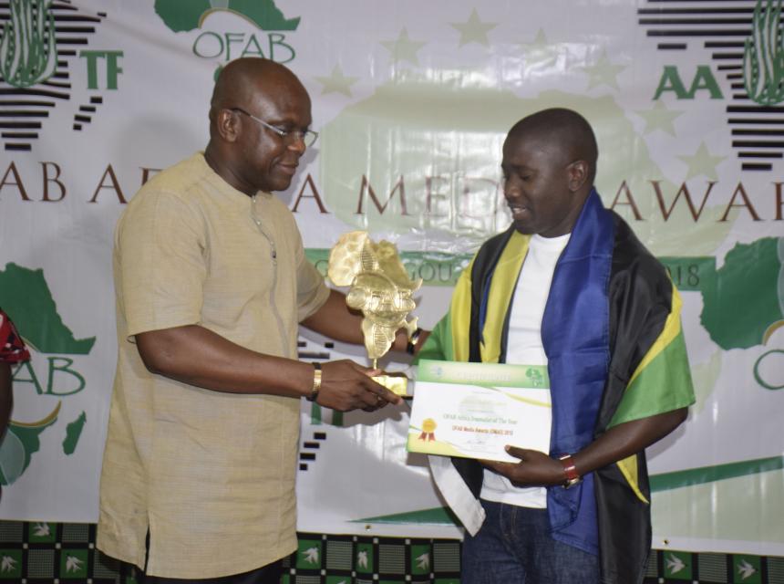 Mr Calvin Edward Gwabara (Right) Receiving OFAB 2018 Journalist of the Year from Hon. Remy Dandjinou (Left) the Burkina Faso Minister for Communication who was the guest of honor 