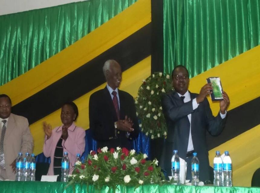  Prof. Gerald C. Monela showing off a token awarded to him during his farewell party. Looking on from right to left is The Chancellor of Sokoine University of Agriculture Hon. Judge (retired) Joseph Sinde Warioba, Deputy Chairperson of SUA Council Prof. Ester Mwaikambo and SUA’s Deputy Vice Chancellor – Administration and Finance Prof. Yonika Ngaga. 